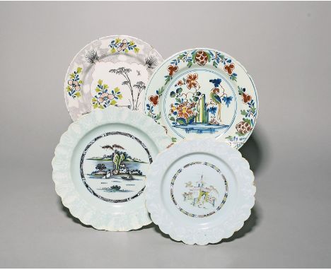 Four delftware plates  c.1730-60, one Bristol and painted with a woolsack panel on a pale powdered manganese ground, another 