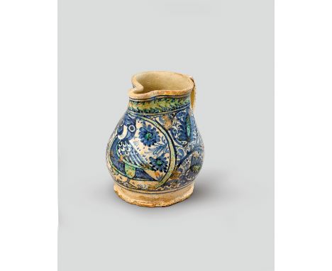 A Montelupo maiolica jug  c.15th century, the swollen body simply painted in blue and green enamels with an owl, contained in