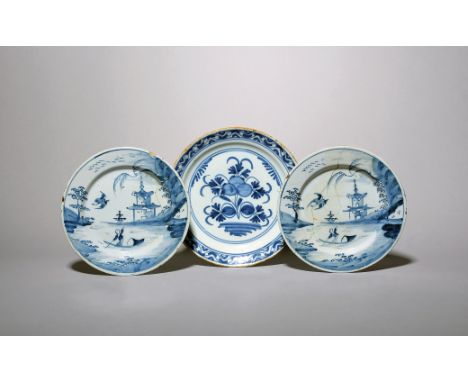 A pair of small delftware plates  c.1720-40, each painted in blue with a Chinese boy punting before a two-storeyed pagoda on 