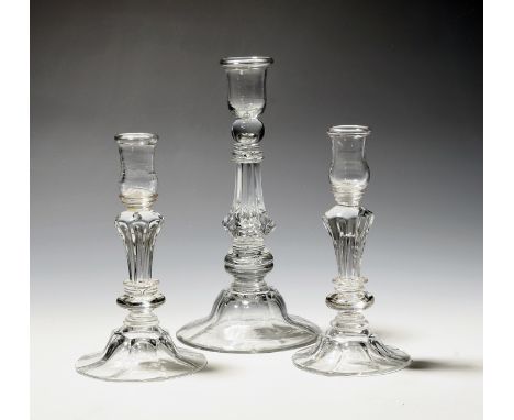 A pair of small moulded glass candlesticks  mid 18th century, the thistle shaped sconces raised on annulated knops above Sile