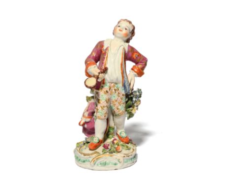 A rare Bow figure of a boy c.1770, standing with his left hand resting on his hip, holding a magnifying glass in his right ha