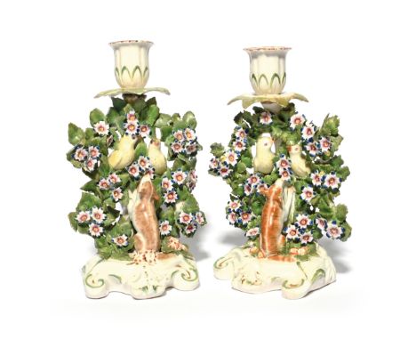 Two Derby candlestick bird figure groups  c.1765, each modelled with a pair of yellow finches perched amid flowering branches