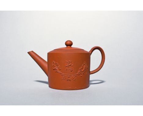 A Staffordshire red ware teapot and cover  c.1760-70, the cylindrical form applied to each side with a bird holding a branch 