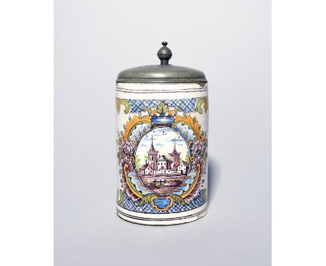 A German faïence pewter-mounted tankard  dated 1778, the cylindrical form painted in polychrome enamels with a panel of build
