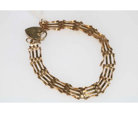 9 carat gold gate bracelet with silver locket.
