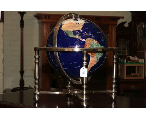 Semi-precious stone terrestrial globe and on four legged stand with centralised compass with box.