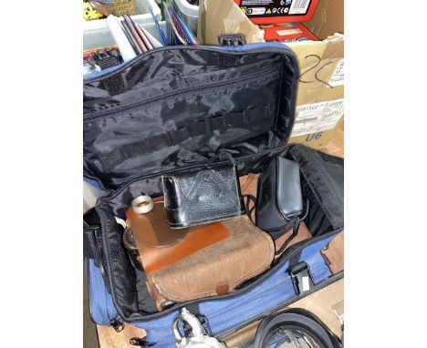 A camera bag of various camera equipment including a box of cameras