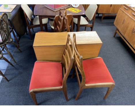 A teak G Plan drop leaf table and four ladder back chairs, the table measures 74cm H, 92cm D, 139cm W, with leaves up