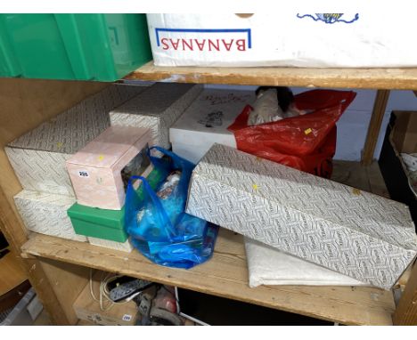 Shelf of boxed dolls