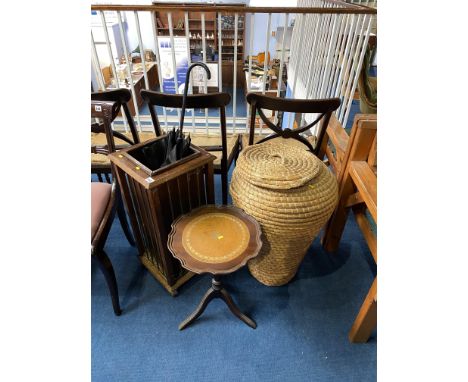 An umbrella stand with vintage umbrella, linen basket and occasional tripod table 