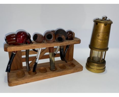 A miner's lamp, 'Hockley Lamp and Limelight Company', 25cm H and a pipe rack with pipes