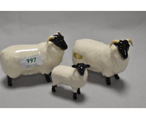 Two Beswick Pottery Black Faced Sheep, model number 1765 designed by Mr Garbet, sold together with a black faced lamb, model 