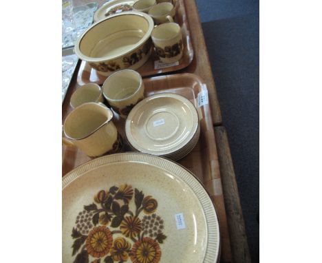 Two trays of Poole pottery coffee and dinner ware items on a brown ground with floral and foliate decoration comprising coffe