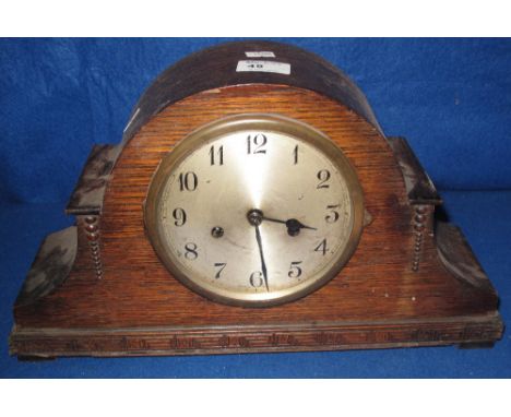 Early 20th Century oak hat shaped two train mantle clock with silvered face.