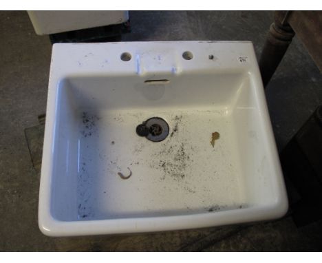 White ceramic butlers type sink with tap holes and over flow.