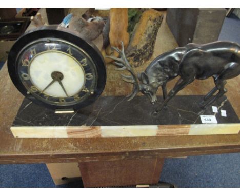 Art deco design clock with standing spelter stag on rectangular marble base.
