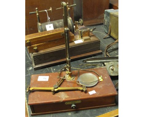 Set of brass apothecaries scales with glass and brass pans on a mahogany drawer base by De Grave Short & Company of London.