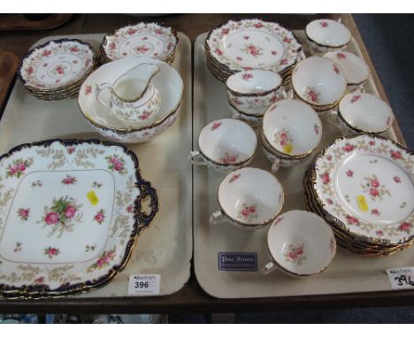Two trays of early 20th Century Coalport tea ware items on a white ground with cobalt blue gilt and floral decoration compris