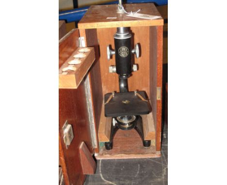 Cased monocular black enamelled microscope by C.Baker London, number 30150.