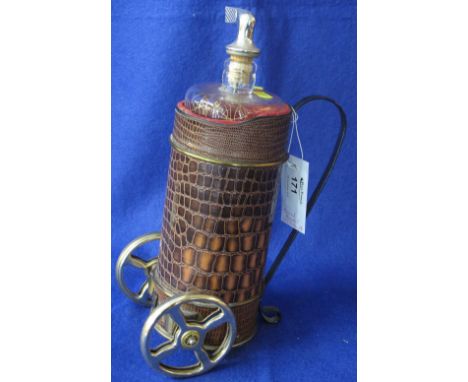 Musical decanter in the form of a golf trolley.