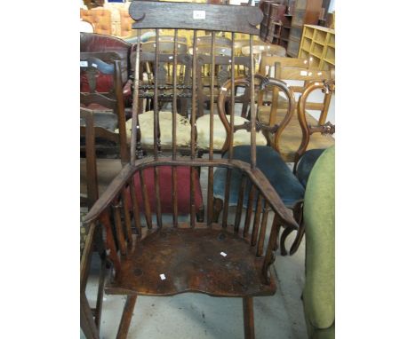 Traditional oak rustic stick back arm chair.