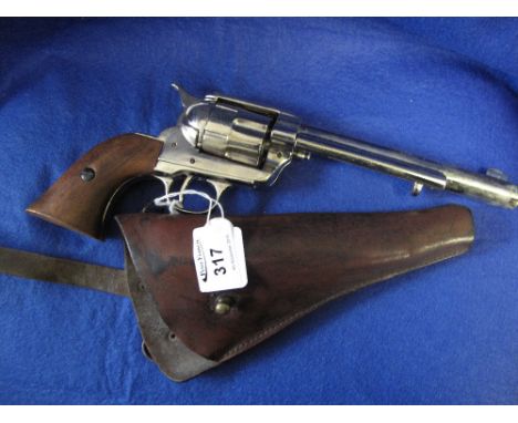 VKA die cast metal model of a long barelled Colt revolver together with a vintage leather holster.