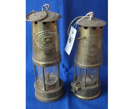 Two similar all brass reproduction miners safety lamps by E.Thomas & Williams Limited and The Protector Lamp and Lighting Com