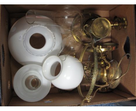 Two gimballed brass oil lamps and another brass hanging lantern with shades and chimneys.