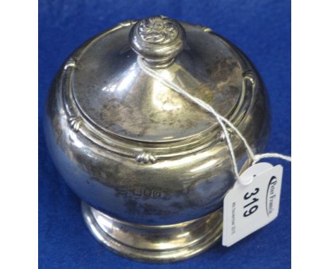 Silver baluster shaped lidded tea caddy with foliate knop.  London hallmark.  Presentation inscription dated 1932.