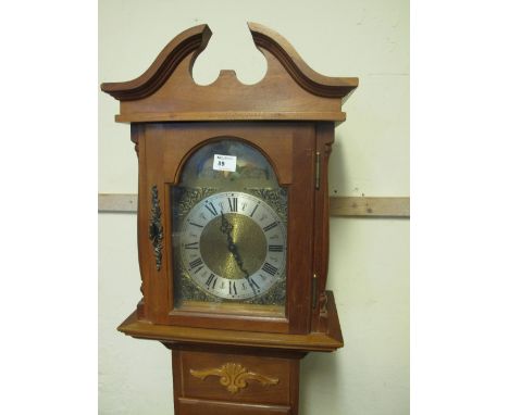 Modern mahogany long case clock with brass face and rolling moon.