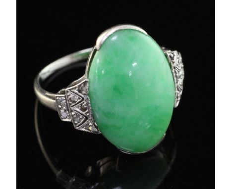 An 18ct white gold, cabochon jadeite and diamond set ring, of oval form, size O.