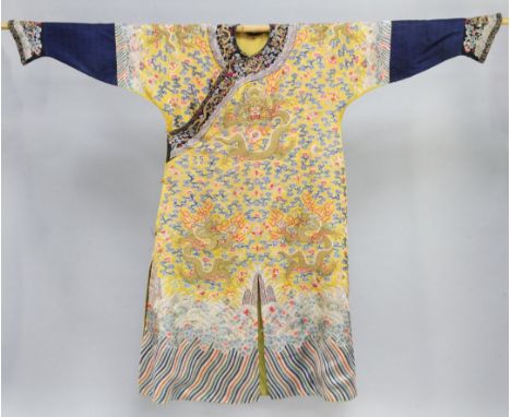 A Chinese Imperial yellow silk 'dragon' robe, Jifu, 19th century, embroidered in satin stitch and gilt wrapped threads with n