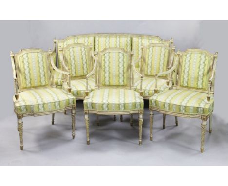 A suite of George III white and gilt seat furniture, comprising five armchairs and a settee, the padded backs within moulded 