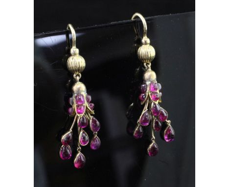 A pair of early 20th century gold and ruby drop earrings, each set with fifteen rubies including seven teardrop shaped caboch