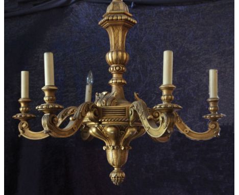 An Italian carved giltwood six branch chandelier, with central gadrooned ball knop carved pineapple finial with long twisted 