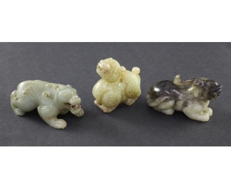 Three Chinese jade figures of mythical beasts, 19th / 20th century, the first of a celadon stone carved in archaistic style w