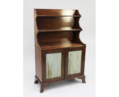 A 19th century mahogany chiffonier, the top fitted with two shelves, with reeded shaped sides above two cupboard doors with p