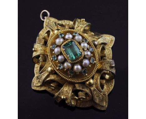 A Victorian gold, emerald and split pearl set oval brooch, with engraved pierced scroll mount and central emerald bordered wi