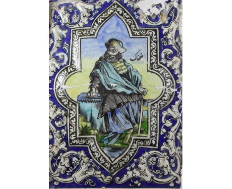 A large Persian polychrome pottery tile, Qajar dynasty, painted with a bearded man seated on a plinth and holding a stick in 