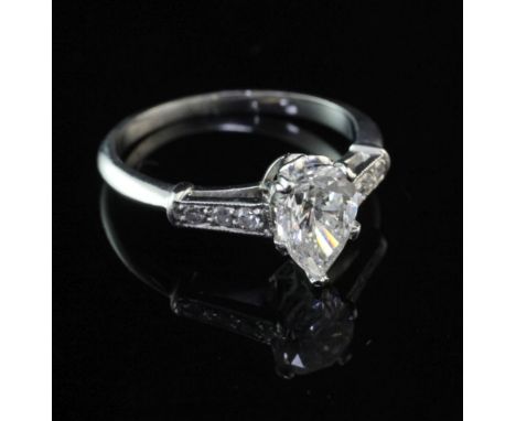 A platinum and single stone pear shaped diamond ring, with graduated diamond set shoulders, with E.G.L. Los Angeles report st