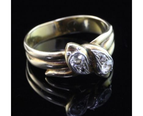 An early 20th century gold and diamond twin serpent ring, set with four old cut stones, size R.