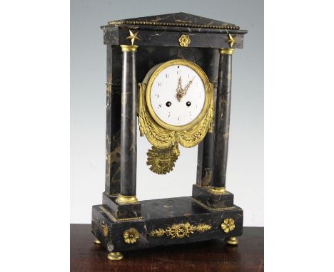 An early 19th century French ormolu mounted marble portico clock, with ormolu swag enamel dial, and later Japy Freres movemen