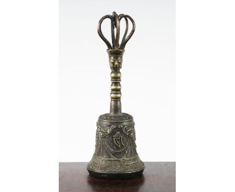 A Tibetan Vajra bell, 17th century, the bell cast with masks and characters, the handle with head and looped crown finial, 21