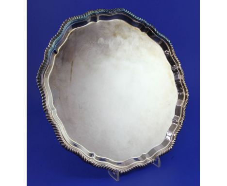 An early 1970's silver salver, of shaped circular form, with gadrooned border, on four scroll feet, E.H. Parkin & Co, Sheffie