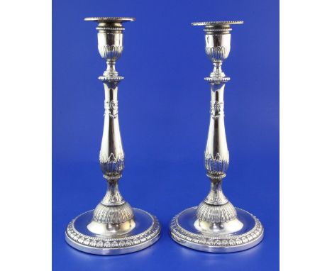A pair of George III silver candlesticks by John Winter & Co, with baluster stem and decorated with acanthus leaves and swag 