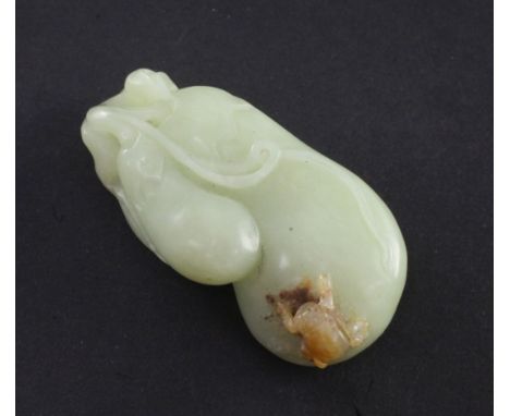 A Chinese yellow and russet jade carving of gourds, 19th/20th century, the carver skillfully carving a raised beetle to a rus