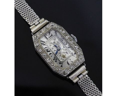 A lady's 1920's platinum and diamond manual wind cocktail watch, with octagonal Arabic dial with tumbling numerals and engrav