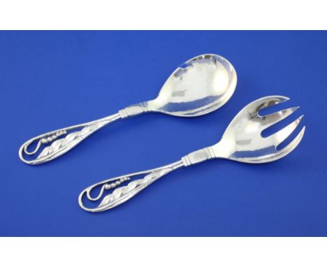 An early 1930's Georg Jensen sterling silver compote spoon and fork, design no.42, with pierced leaf and berry handles, impor