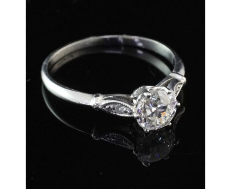 A platinum and single stone diamond ring with diamond set shoulders, the central stone weighing approximately 0.61ct, size L.