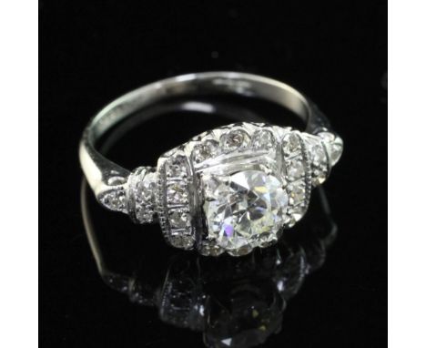 A platinum and iridium, diamond cluster ring, of tonneau form, with central stone weighing approximately in excess of 0.70ct,